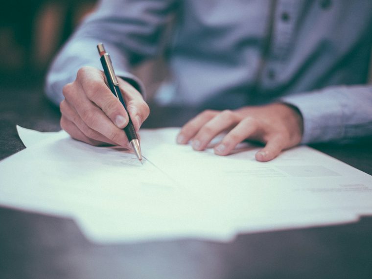 Client reviewing and signing a personal loan agreement